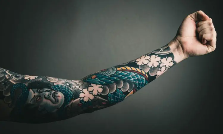 Brazo tatuado con diseño japonés tradicional.