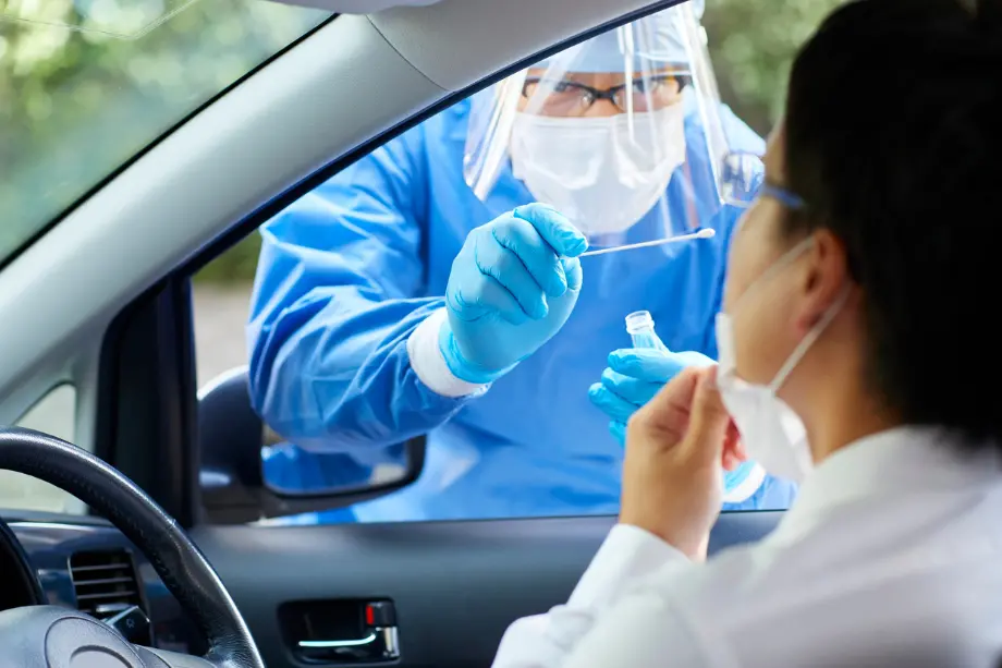 pausa en pandemia prueba COVID desde el automóvil con personal sanitario