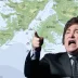 Javier Milei gesticulando en un discurso con un mapa geopolítico de las Islas Malvinas de fondo.