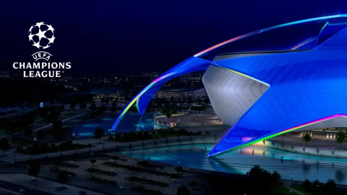 Logo de la UEFA Champions League junto a la estructura de un estadio iluminado de azul en la noche.