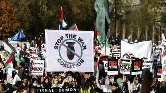 Manifestantes en Londres con pancartas de Stop the War Coalition y banderas palestinas.