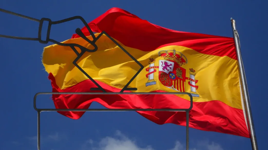 Ilustración de una mano introduciendo una papeleta en una urna electoral sobre la bandera de España ondeando al viento.